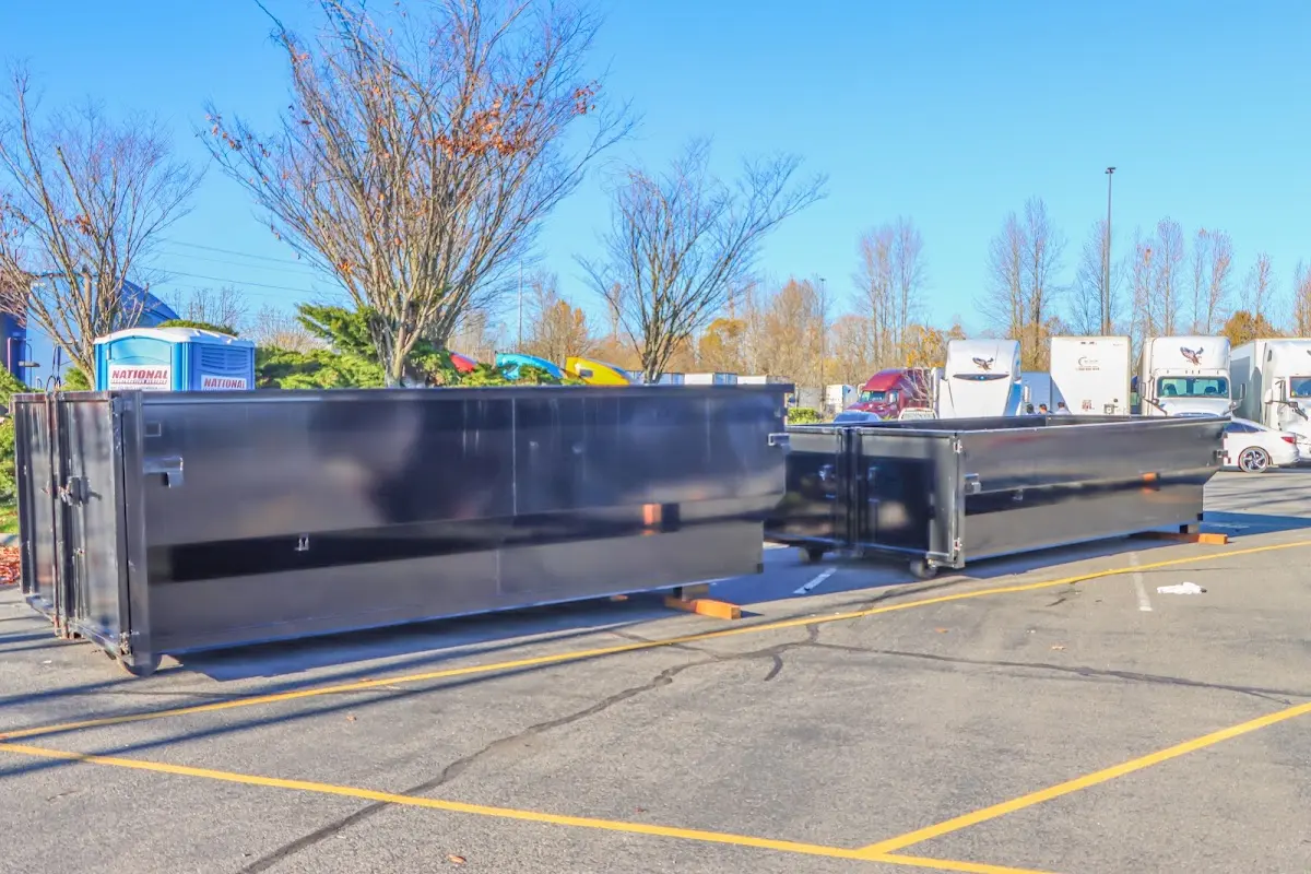 Professional dumpster rental service with roll-off container on residential driveway in Elmsford